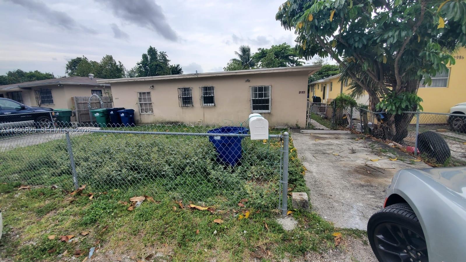 2980 Northwest 91st Street, Unit 1 Miami, FL 33147 - Photo 1 of 9 a view of backyard with outdoor seating and green space