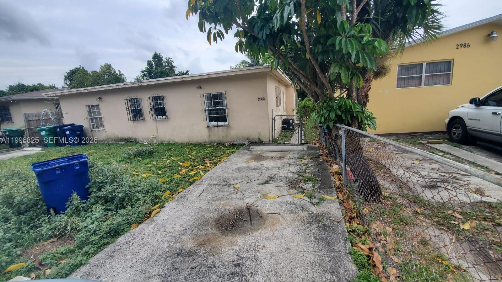 2980 Northwest 91st Street, Unit 1 Miami, FL 33147 - Photo 5 of 9 a backyard of a house with barbeque oven and outdoor seating