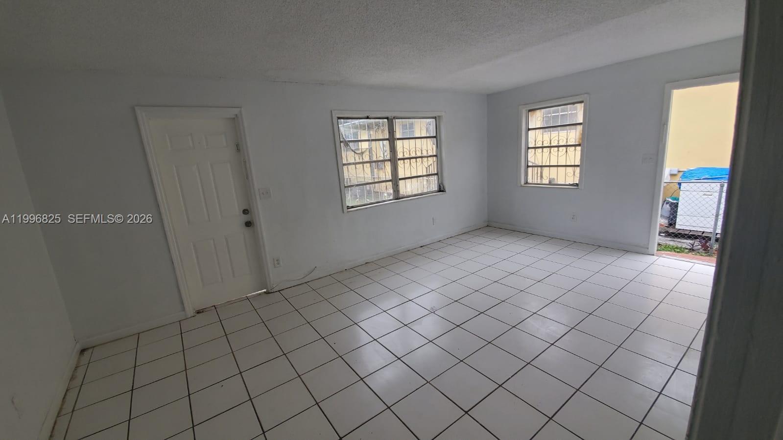 2980 Northwest 91st Street, Unit 1 Miami, FL 33147 - Photo 7 of 9 an empty room with windows