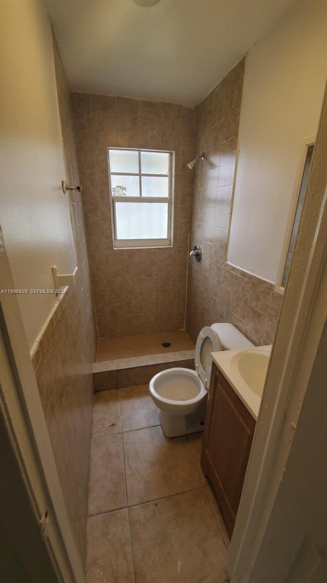 2980 Northwest 91st Street, Unit 1 Miami, FL 33147 - Photo 8 of 9 a bathroom with a toilet a sink and bathtub