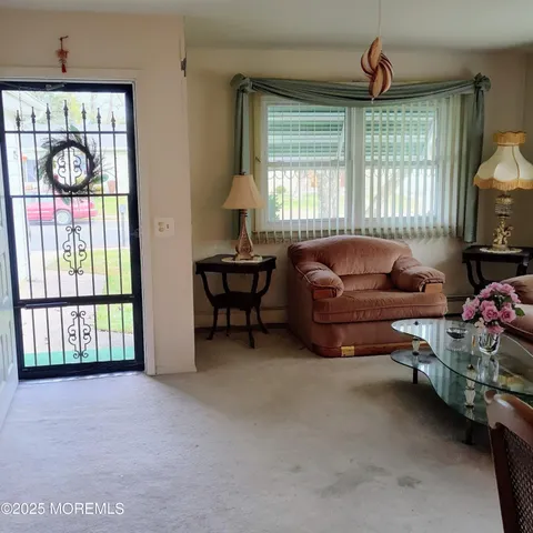 a living room with furniture a window and a chandelier