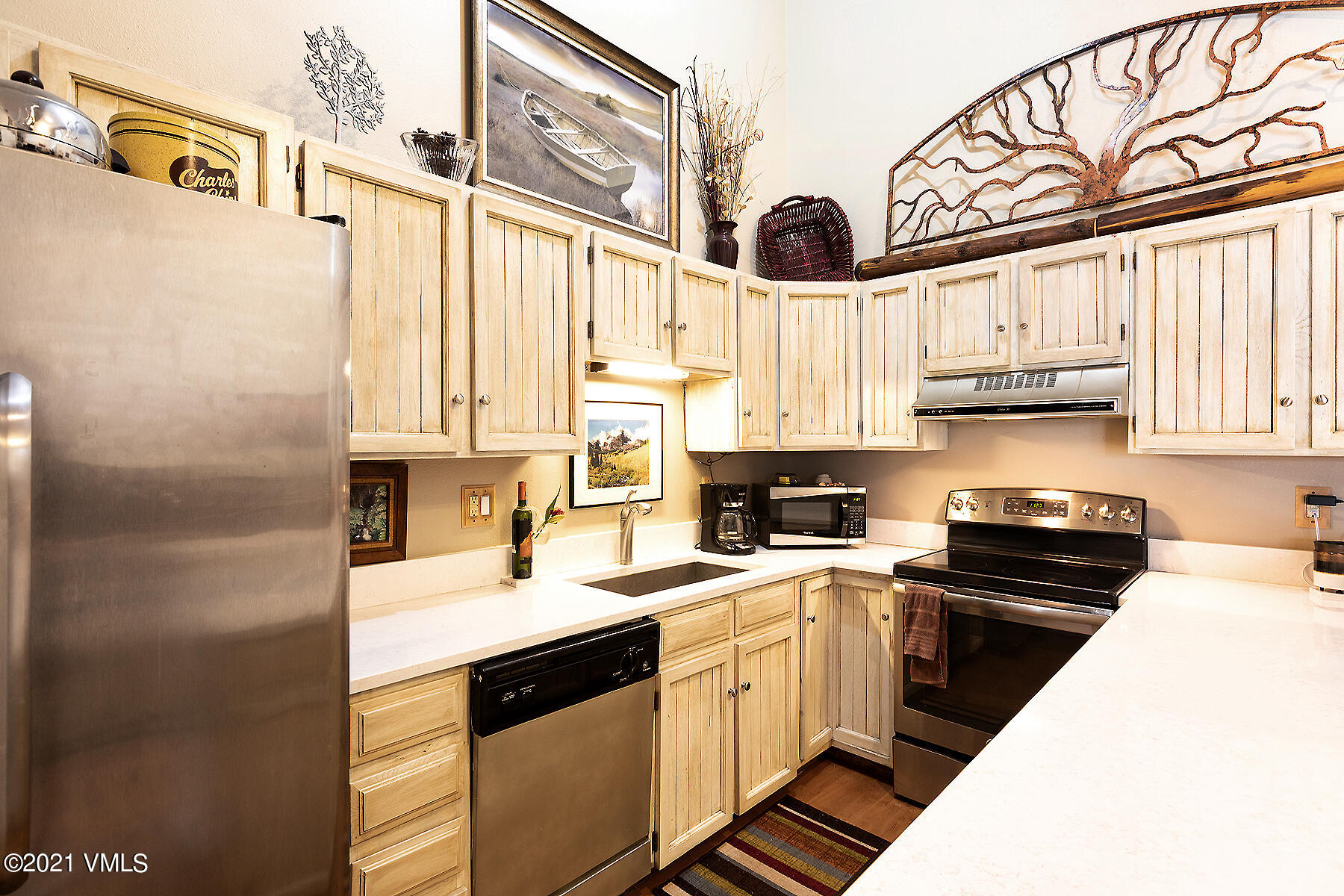 165 Gopher Road, Unit E24 Avon, CO 81620 - Photo 1 of 12 a kitchen with stainless steel appliances a sink a stove a refrigerator and cabinets