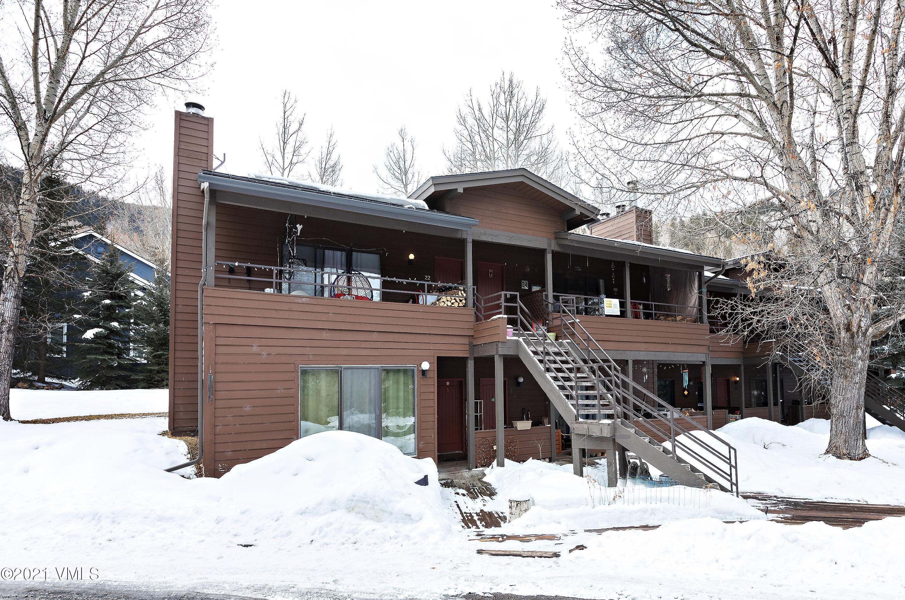 165 Gopher Road, Unit E24 Avon, CO 81620 - Photo 12 of 12 a front view of a house with a yard covered with snow