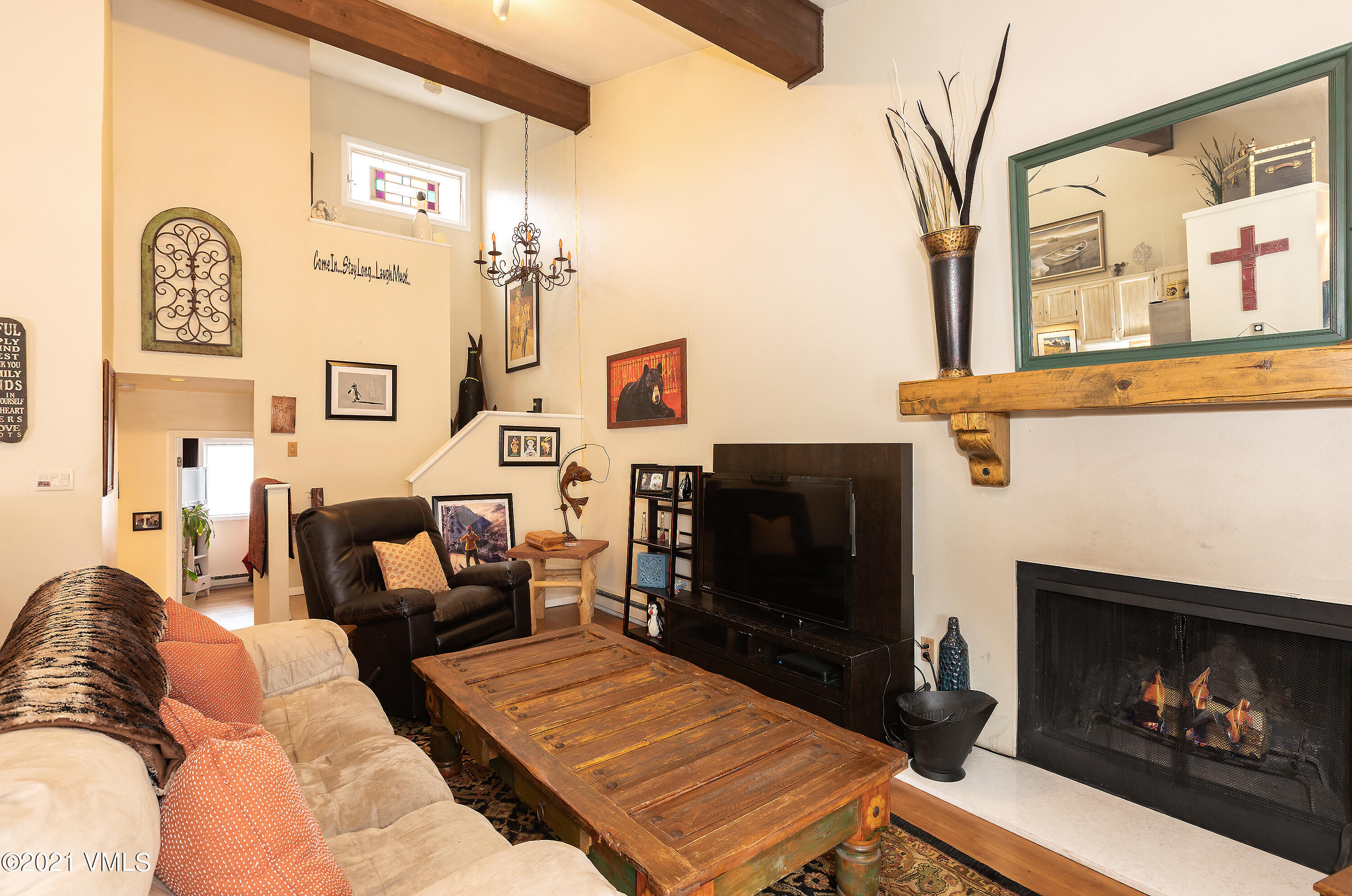 165 Gopher Road, Unit E24 Avon, CO 81620 - Photo 2 of 12 a living room with furniture a flat screen tv and a fireplace