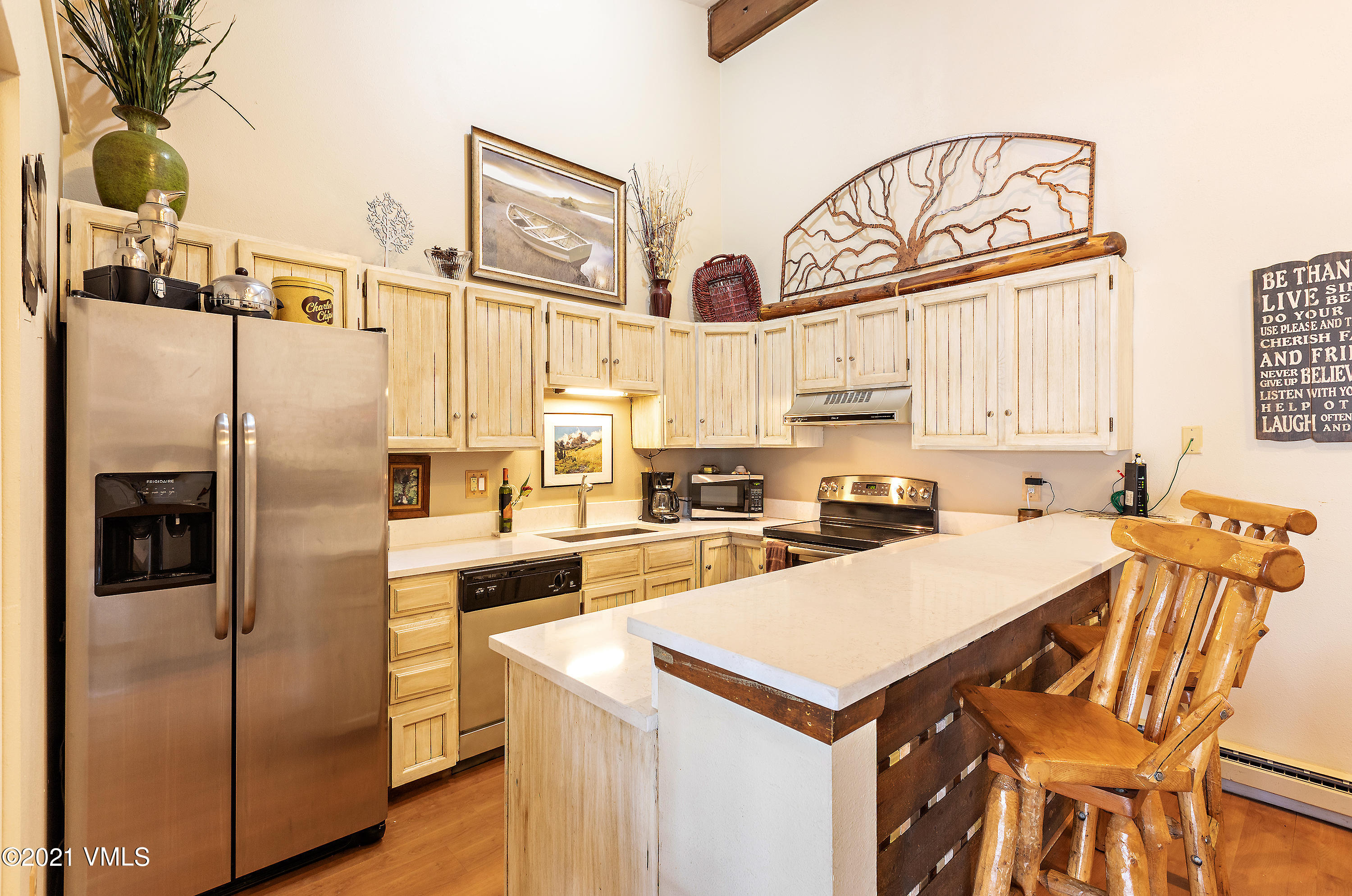 165 Gopher Road, Unit E24 Avon, CO 81620 - Photo 4 of 12 a kitchen with stainless steel appliances a refrigerator a stove a sink and white cabinets