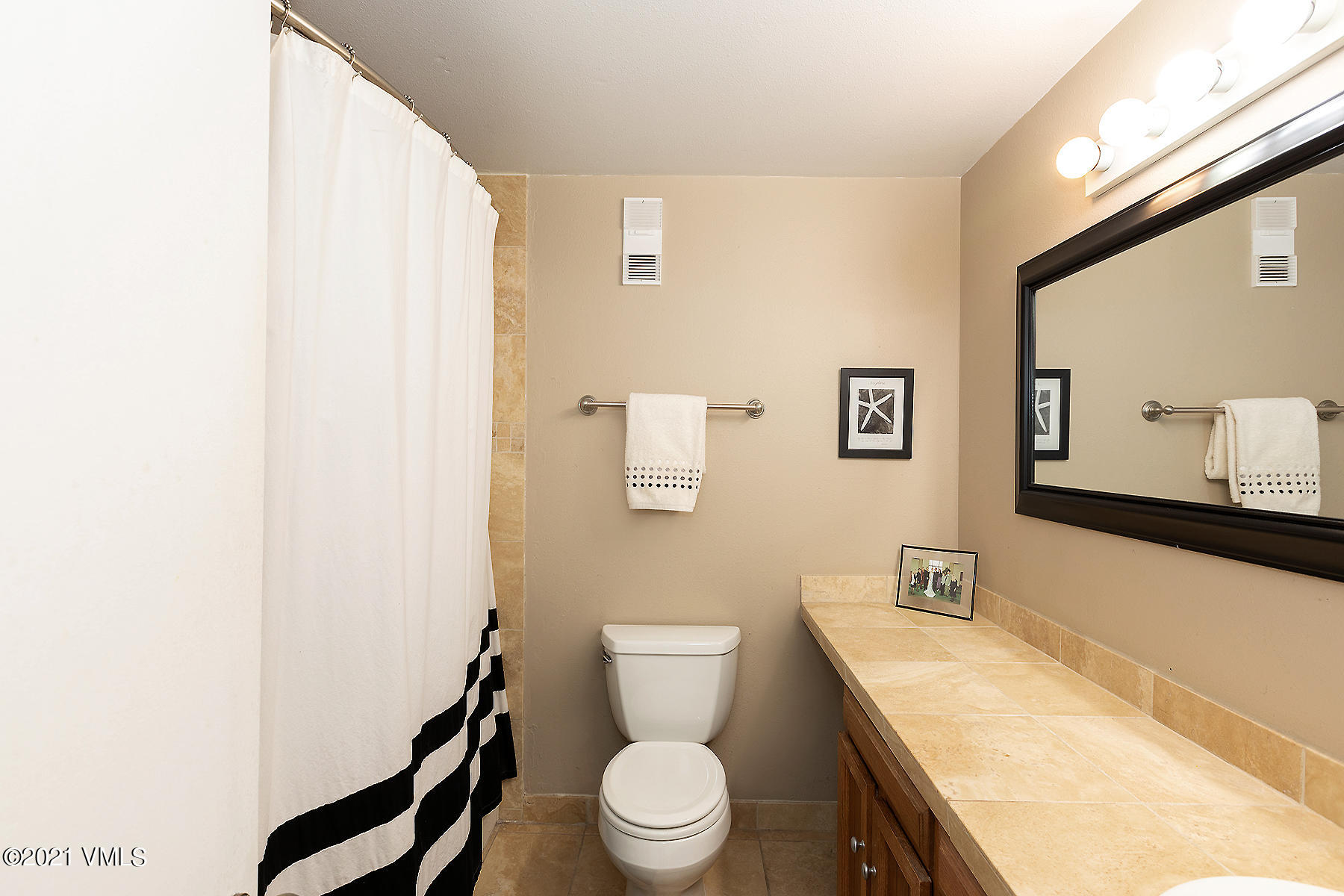 165 Gopher Road, Unit E24 Avon, CO 81620 - Photo 6 of 12 a white toilet sitting next to a bathroom sink