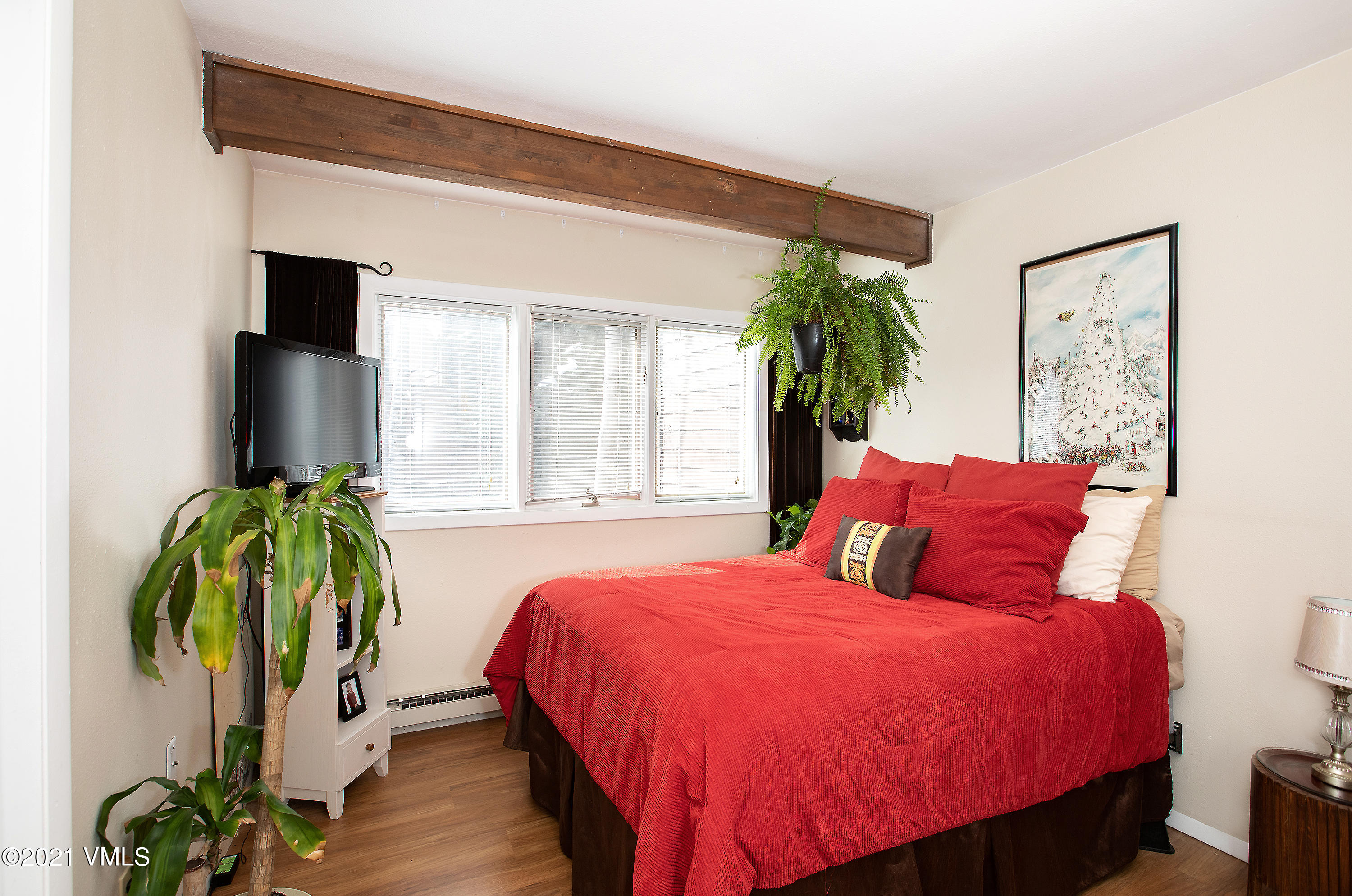 165 Gopher Road, Unit E24 Avon, CO 81620 - Photo 7 of 12 a bedroom with a bed table flowerpot and window