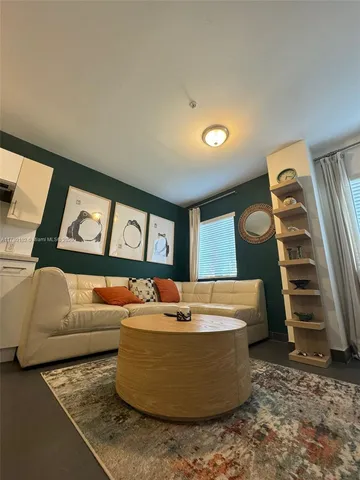 a living room with furniture and stairs