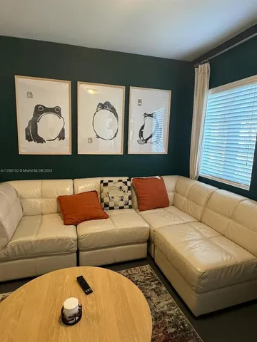 a living room with a couch and cabinets