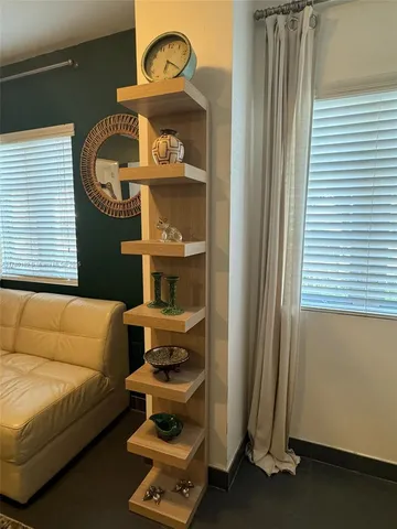 a living room with a bed and a window