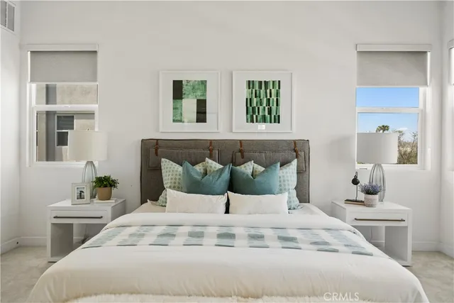 a large white bed in a white room