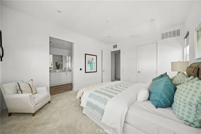 a spacious bedroom with a bed and a couch