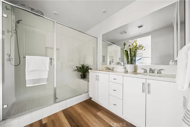 a bathroom with a shower sink and mirror