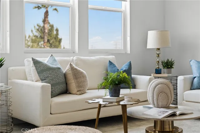 a living room with furniture and a potted plant