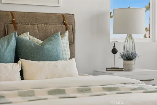 a living room with a couch and a potted plant on it