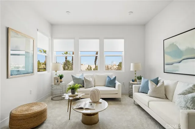 a living room with furniture and a potted plant