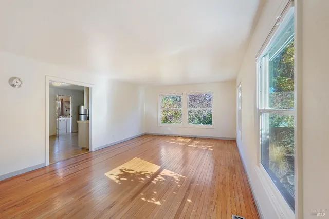 a view of a livingroom with wooden floor and fireplace