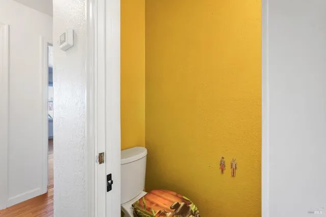 a view of a room with wooden floor and window