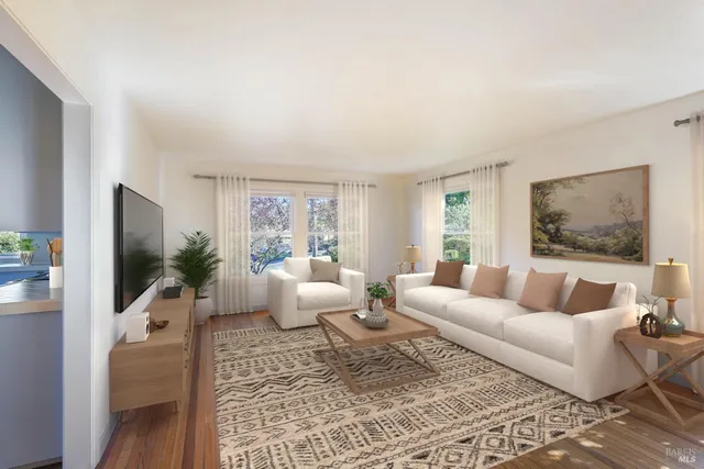 a living room with furniture a flat screen tv and a fireplace