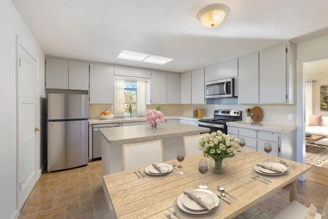 a view of a dining room with furniture and a potted plant