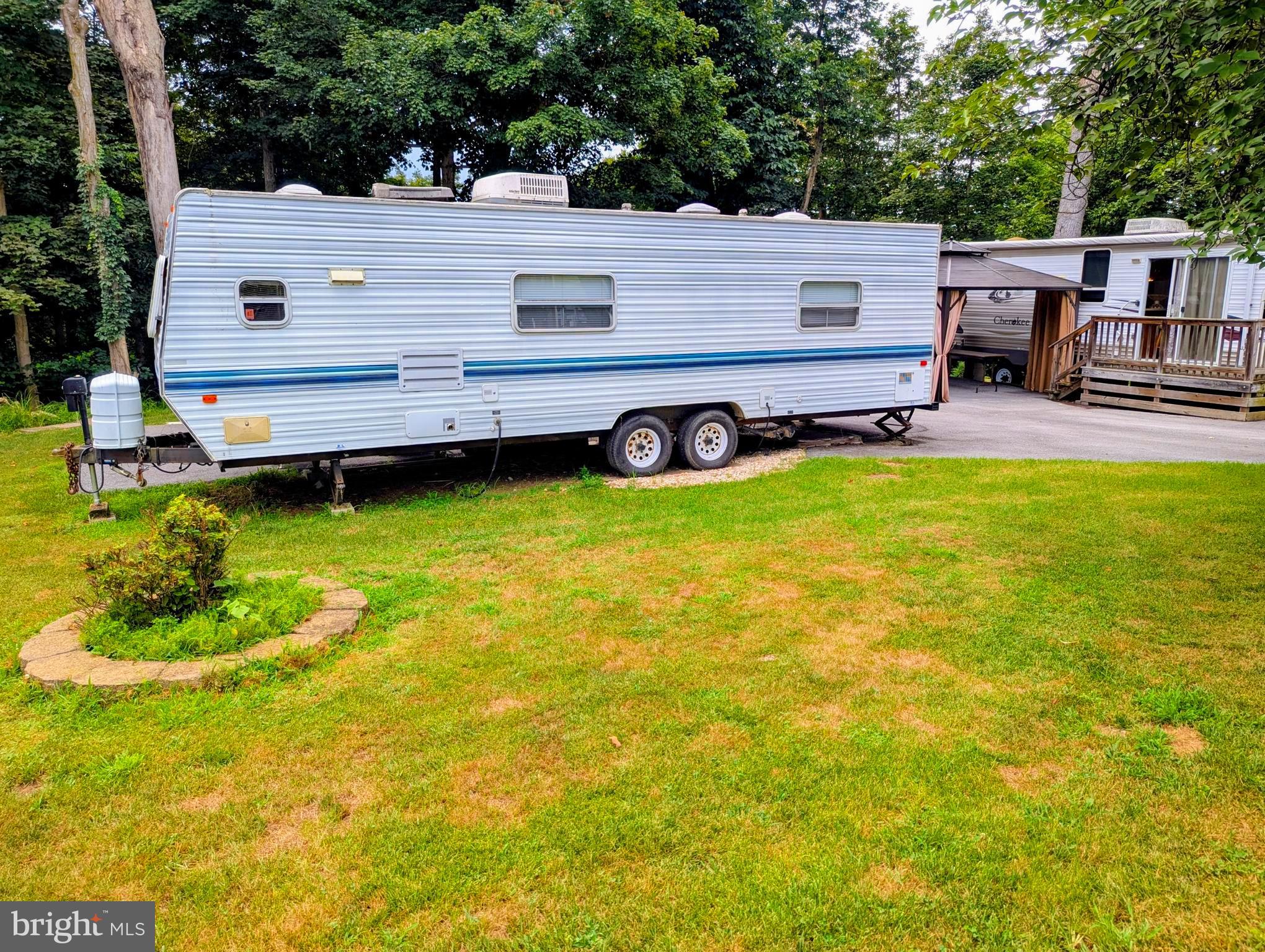 71 & 72 Boo Boo Boulevard Falling Waters, WV 25419 - Photo 2 of 13 a view of a house with backyard and sitting area