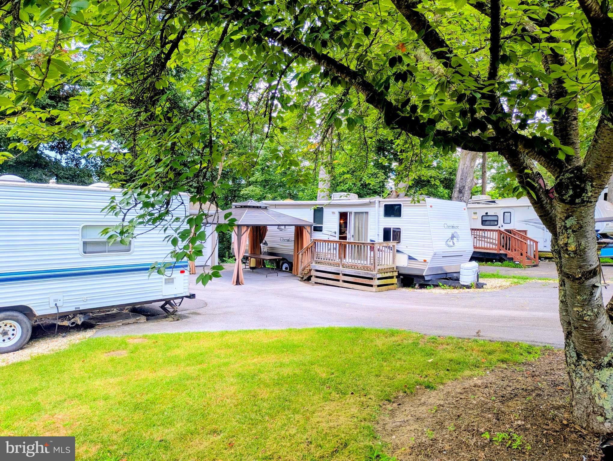 71 & 72 Boo Boo Boulevard Falling Waters, WV 25419 - Photo 3 of 13 a view of a house with backyard porch and sitting area