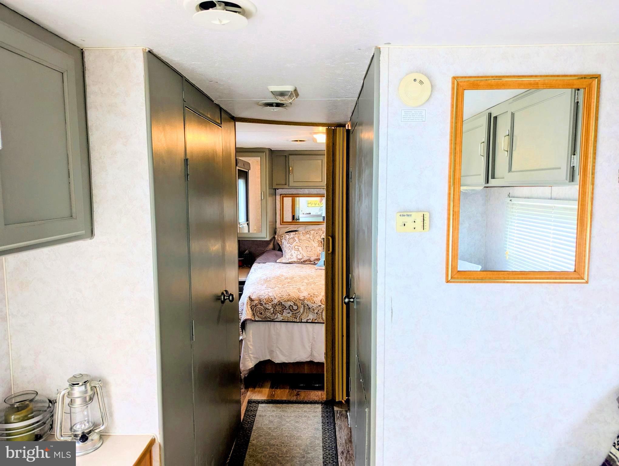 71 & 72 Boo Boo Boulevard Falling Waters, WV 25419 - Photo 9 of 13 a bedroom with a bed and a mirror