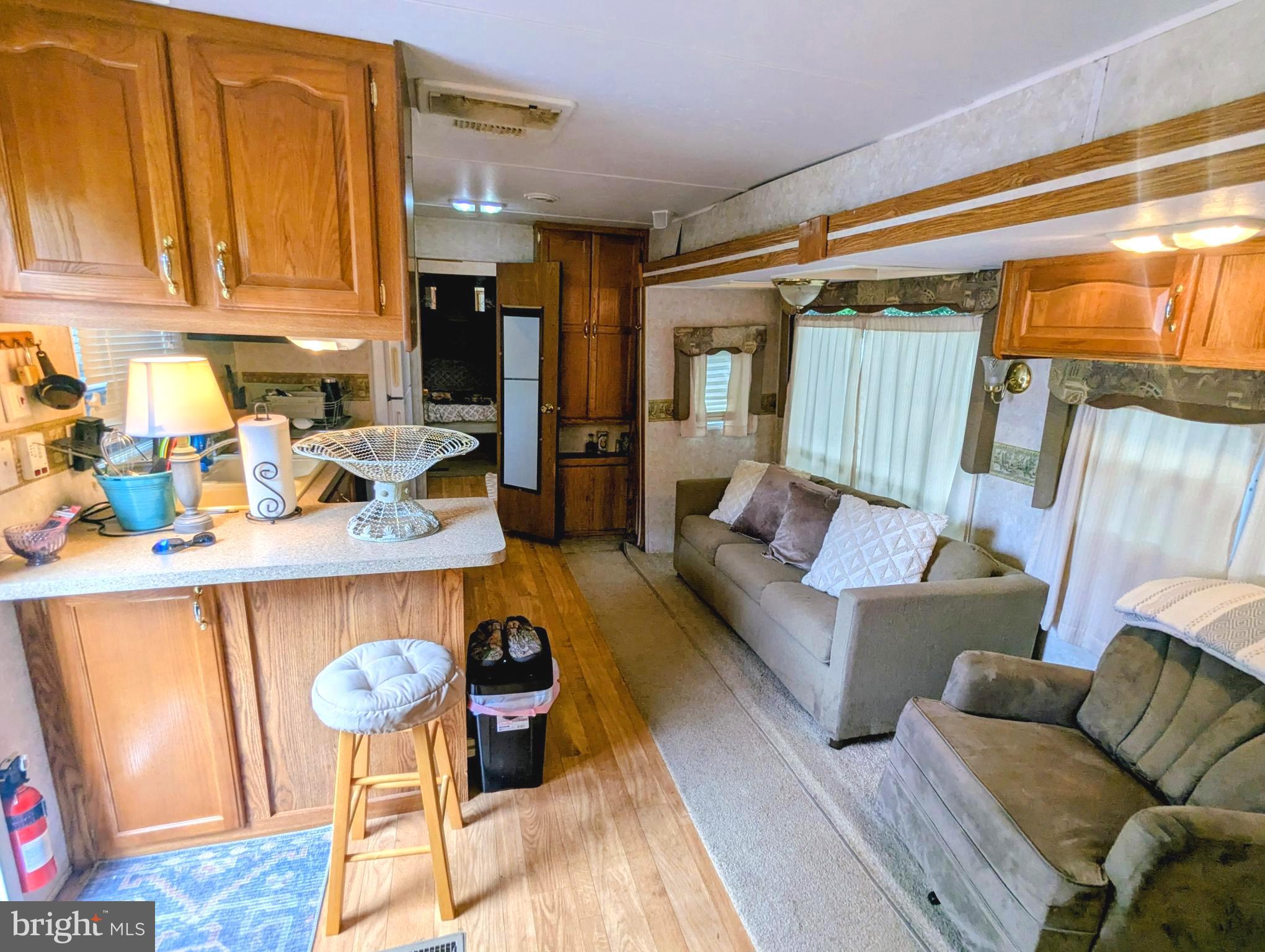71 & 72 Boo Boo Boulevard Falling Waters, WV 25419 - Photo 10 of 13 a living room with furniture and a kitchen area