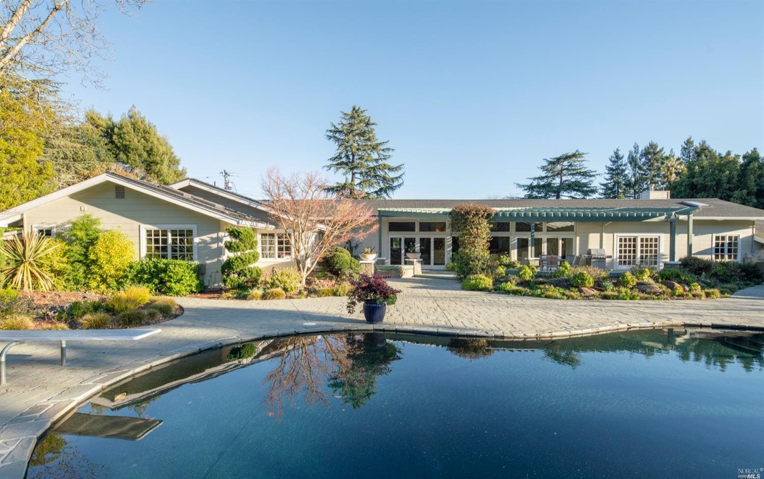 135 Montecito Road San Rafael, CA 94901 - Photo 1 of 1 a front view of a house with swimming pool having outdoor seating