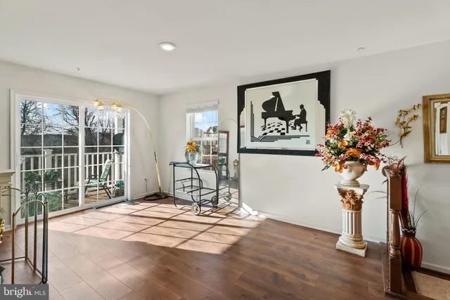 a view of a room with wooden floor and a large window