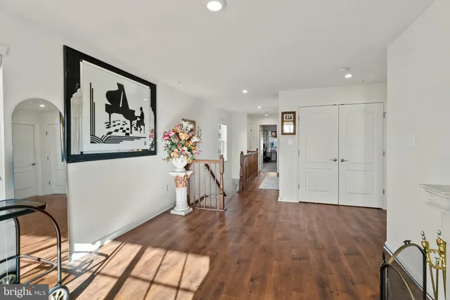 a view of a hallway with wooden floor and a workspace