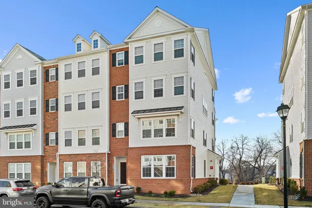a front view of a residential apartment building with a yard