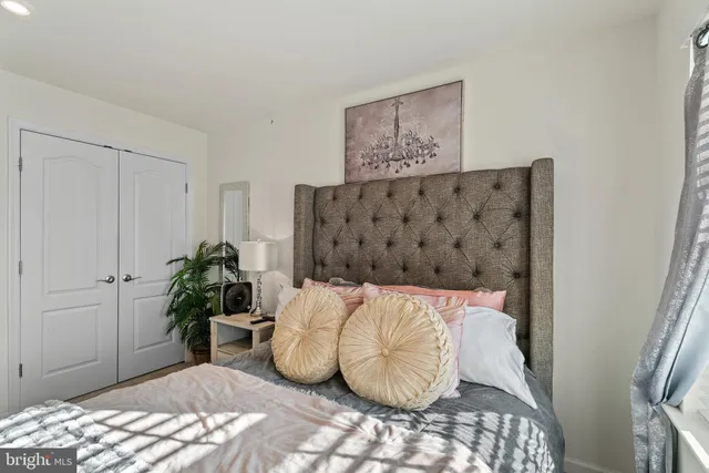 a bed room with furniture and a potted plant