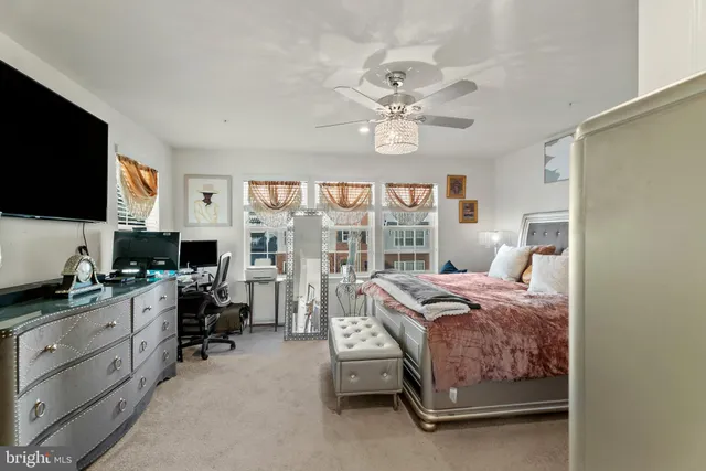 a bedroom that has a bed and a flat screen tv