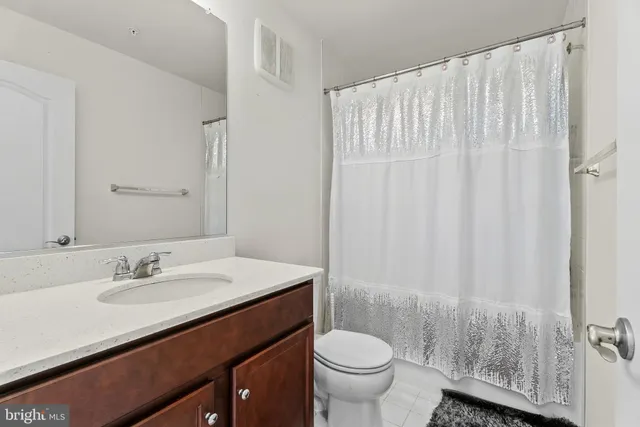 a bathroom with a sink toilet and a mirror