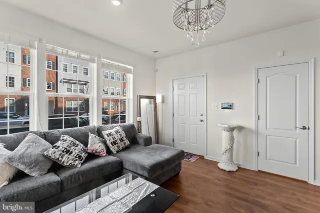 a living room with furniture and a chandelier