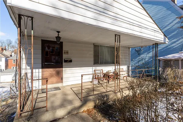 a backyard of a house with table and chairs