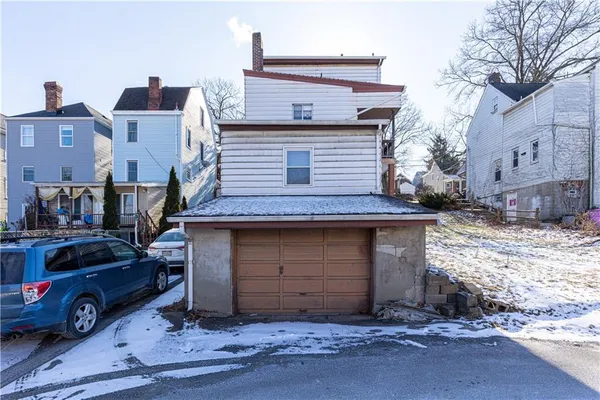 a front view of a house with parking space