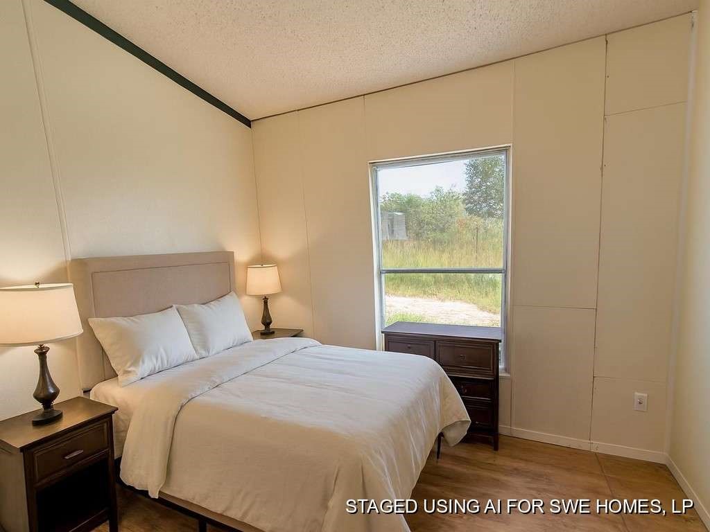 6430 Brockstein Road Sealy, TX 77474 - Photo 6 of 7 a bedroom with a bed and a window