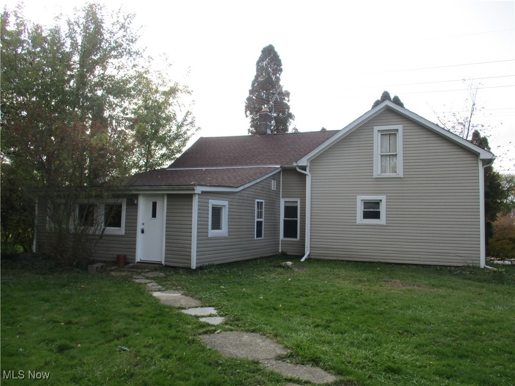15401 A Madison Road Middlefield, OH 44062 - Photo 4 of 17 Rear view of property featuring a lawn