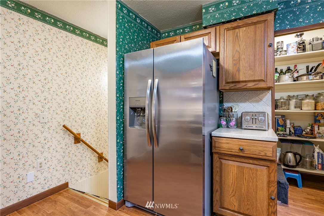 3017 Douglas Road Ferndale, WA 98248 - Photo 12 of 35 a kitchen with metallic refrigerator freezer and a dishwasher