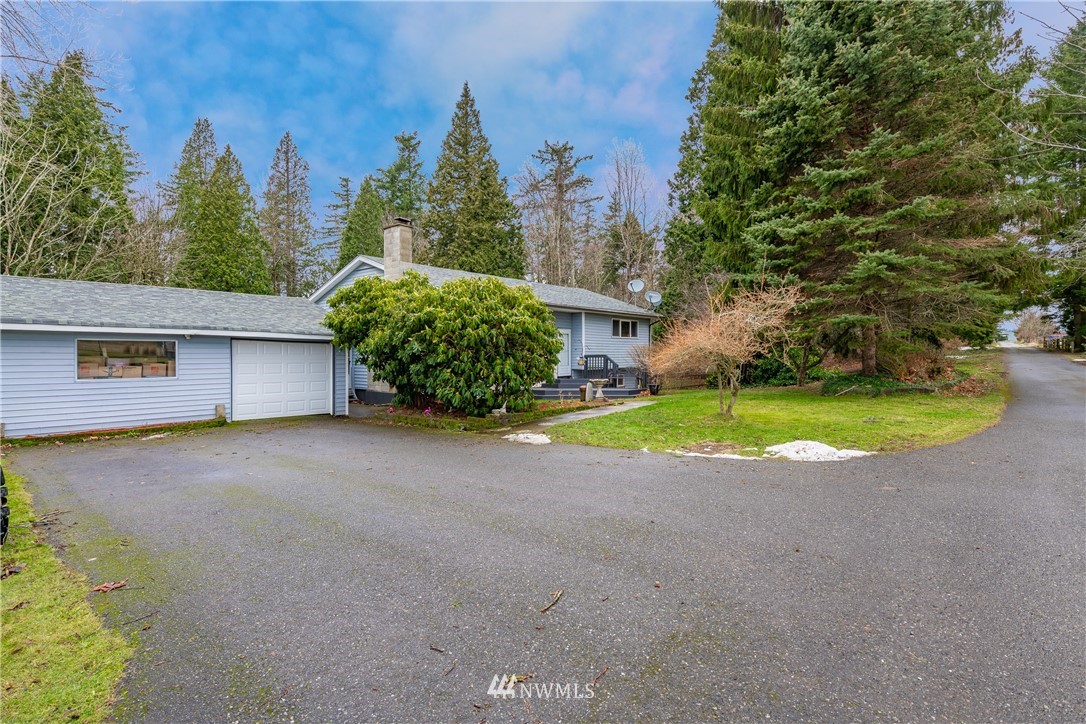 3017 Douglas Road Ferndale, WA 98248 - Photo 35 of 35 a view of a house with backyard and bushes