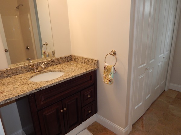 80 Locust Street Brockton, MA 02301 - Photo 11 of 20 a bathroom with a granite countertop sink and mirror