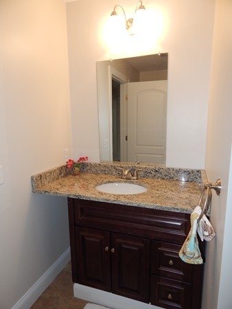 80 Locust Street Brockton, MA 02301 - Photo 12 of 20 a bathroom with a granite countertop sink and a mirror