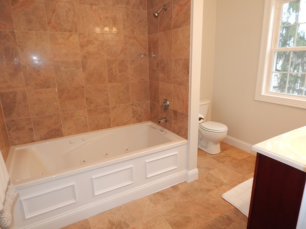 80 Locust Street Brockton, MA 02301 - Photo 13 of 20 a bathroom with a bathtub and a toilet