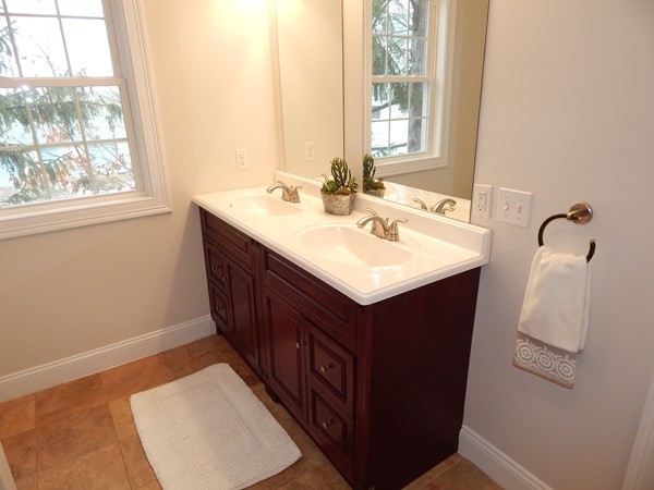 80 Locust Street Brockton, MA 02301 - Photo 14 of 20 a bathroom with a sink vanity and a mirror