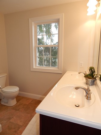 80 Locust Street Brockton, MA 02301 - Photo 15 of 20 a bathroom with a sink a toilet and a window