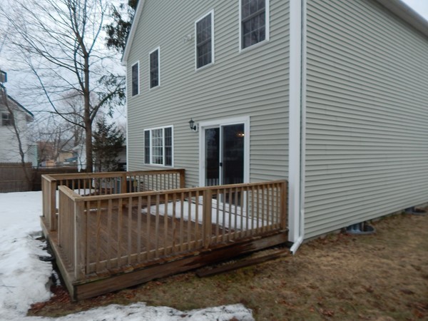 80 Locust Street Brockton, MA 02301 - Photo 20 of 20 a view of a deck with a large window and wooden fence