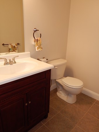 80 Locust Street Brockton, MA 02301 - Photo 3 of 20 a bathroom with a toilet a sink and mirror
