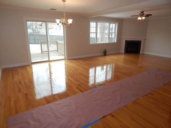 80 Locust Street Brockton, MA 02301 - Photo 4 of 20 a view of a living room with hardwood floor and windows